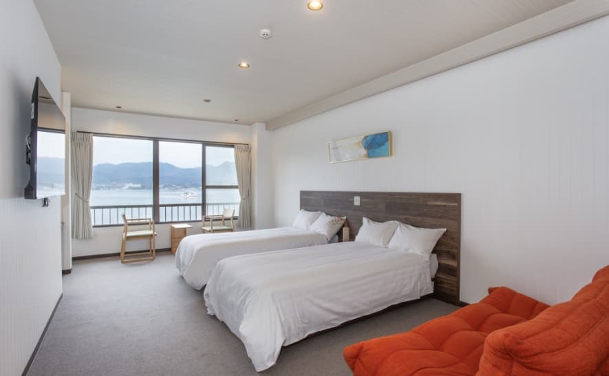 Sea-side Western-style room at Sakuraya with twin beds and a view of the Seto Inland Sea