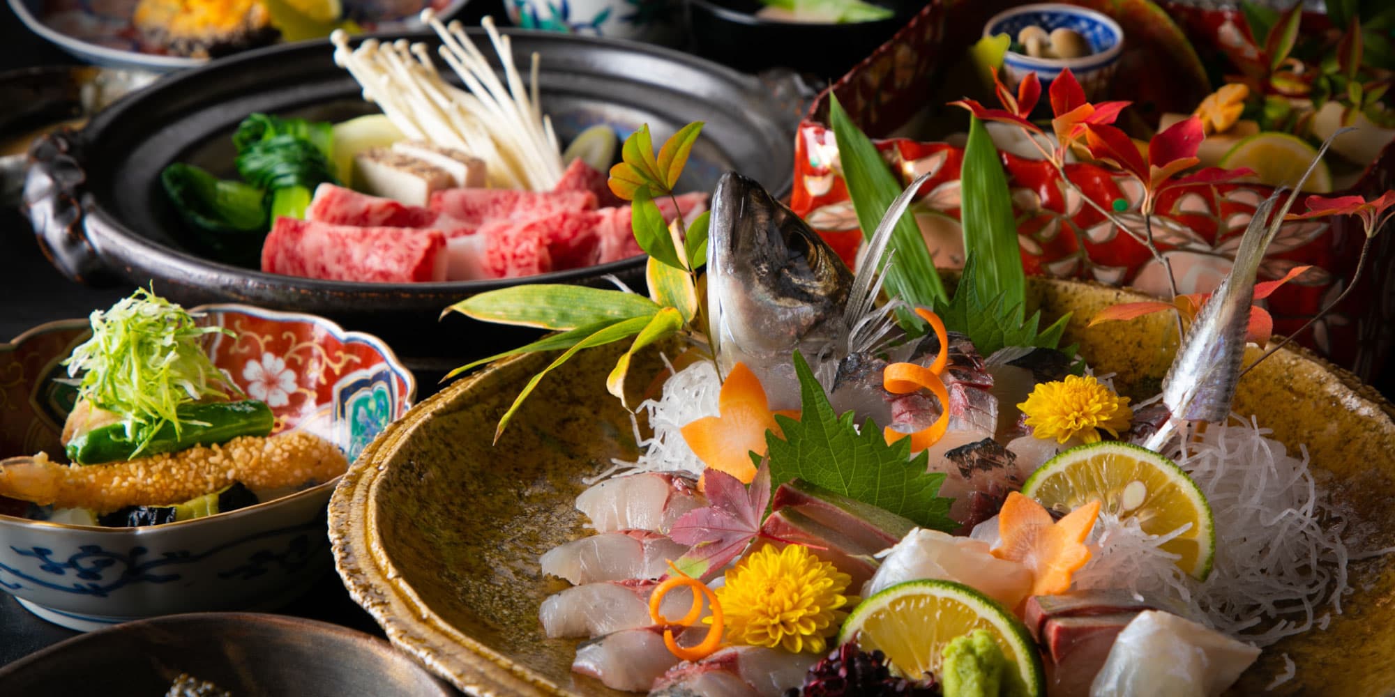 Kaiseki dinner spread with fresh sashimi platter and wagyu hot pot courses at Yufuin Kazenomori