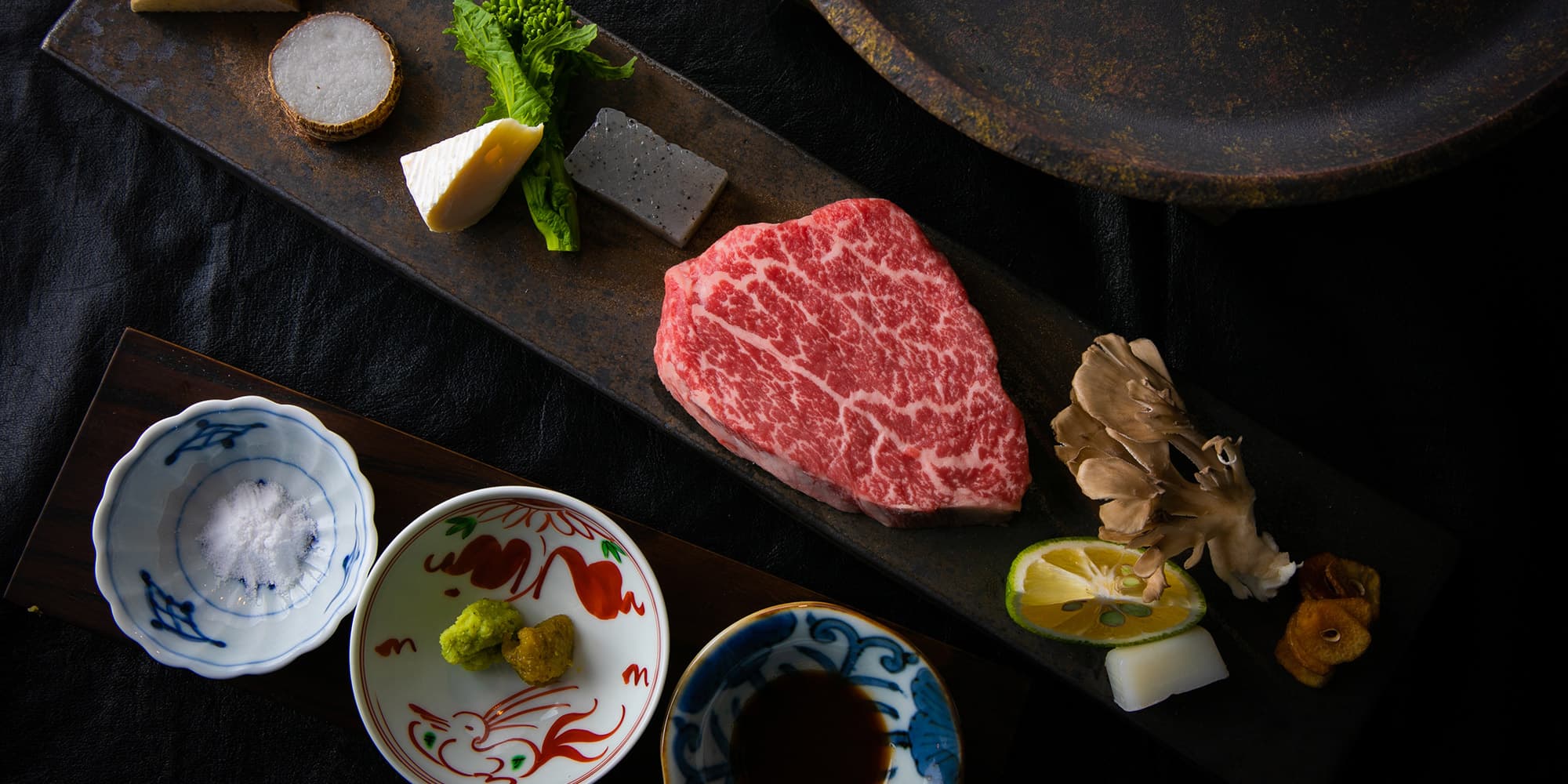 Marbled Bungo wagyu beef course plated with condiments and mushrooms at Yufuin Kazenomori