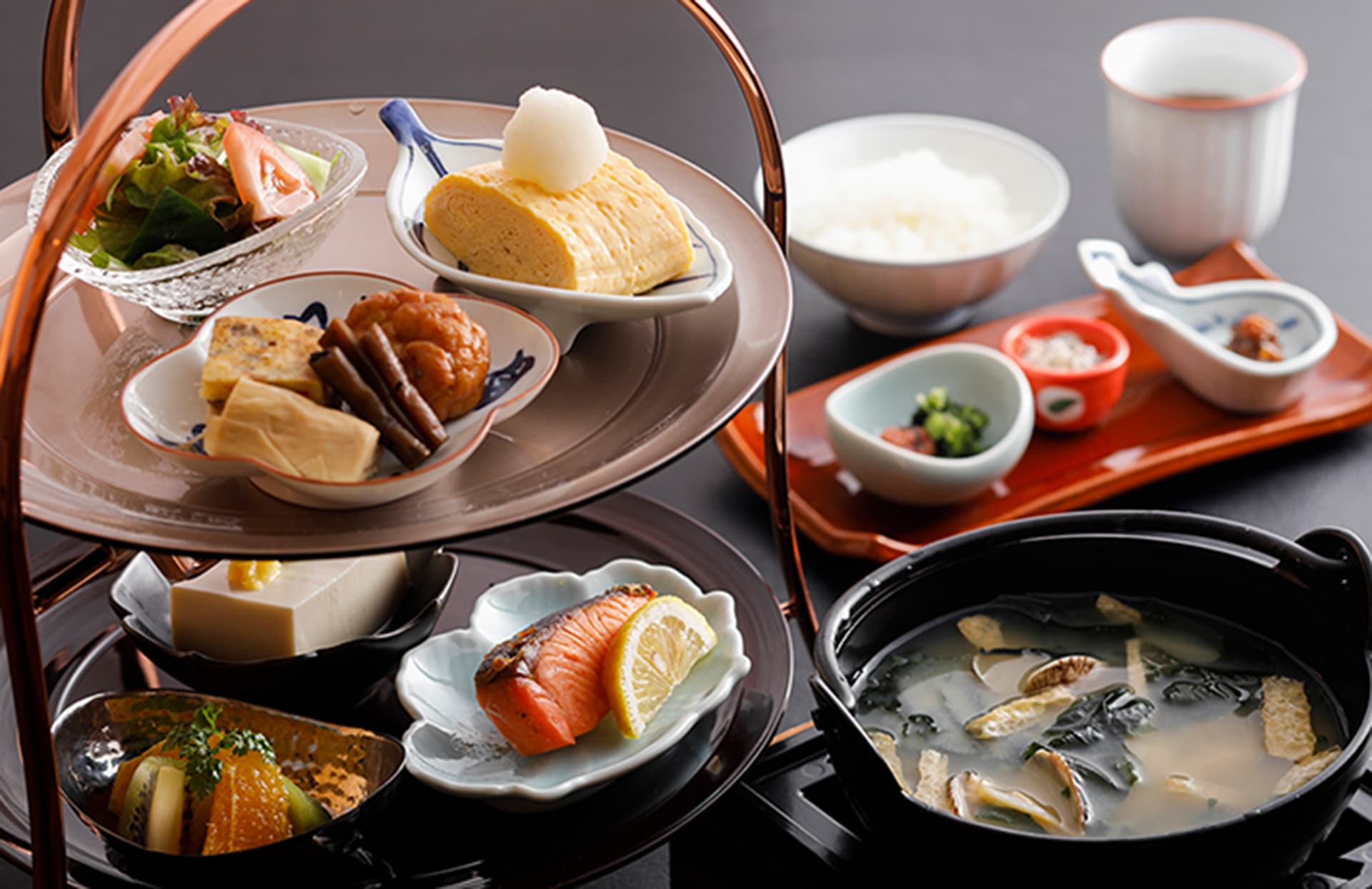 Japanese breakfast set at Miyukiso Hanamusubi with tiered dishes, grilled salmon, tamagoyaki, rice and clam miso soup