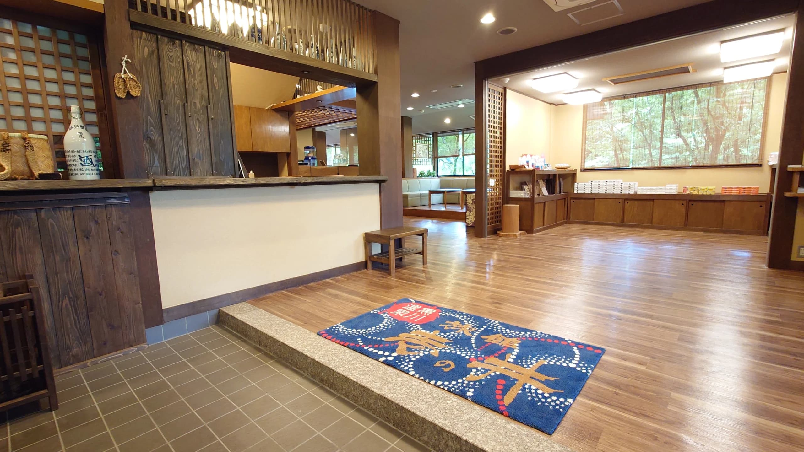 Tatami guest room with low table and garden-facing windows at Ichinoi