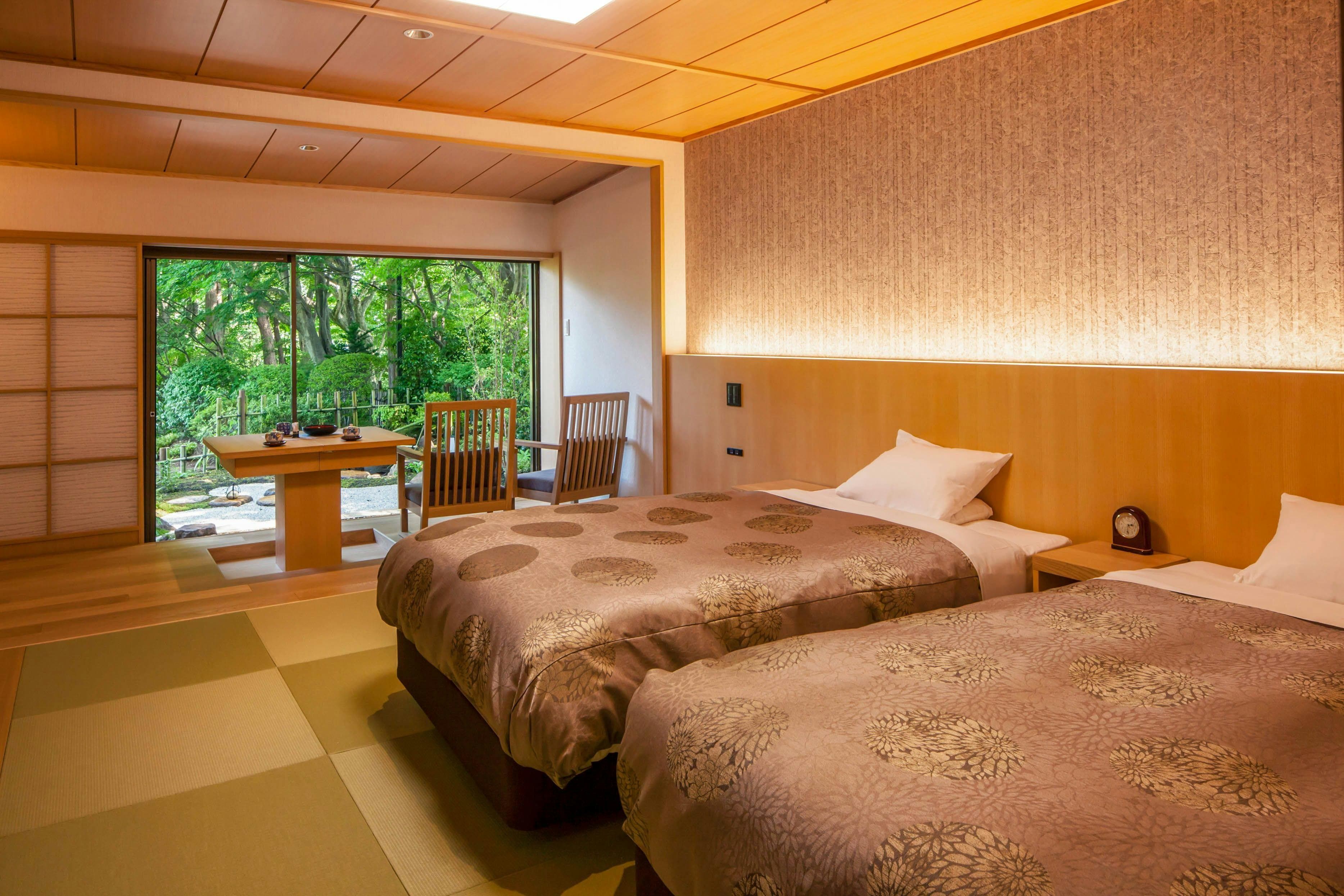 Japanese-style guest room with twin beds and garden view