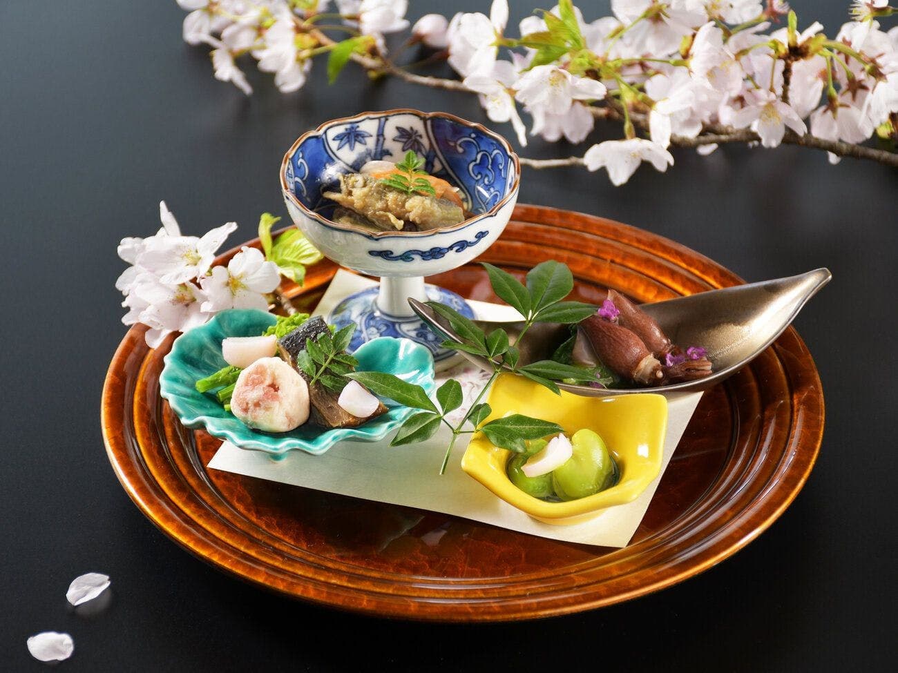 Seasonal kaiseki appetizer plate with cherry blossom garnish