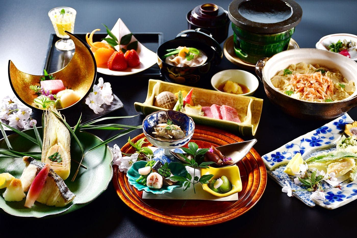 Multi-course kaiseki dinner spread with wagyu beef and hot pot