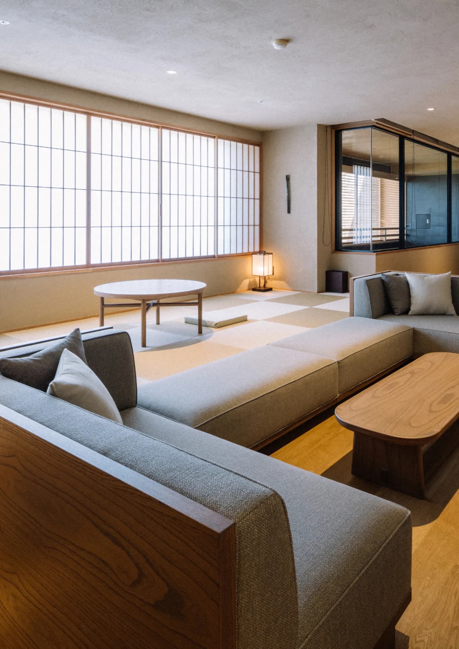 Minimalist tatami lounge with low sofas and shoji-screen windows at Koran no Yu Kinkouroh in Ibusuki