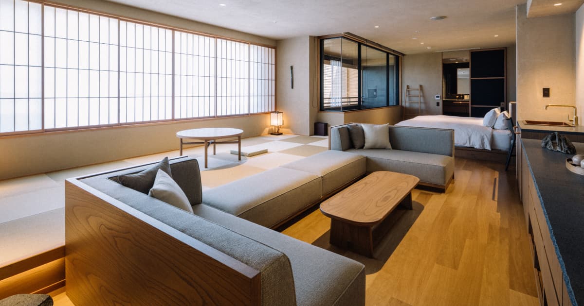 Spacious modern Japanese suite with tatami lounge, sofas and a bedroom area at Koran no Yu Kinkouroh in Ibusuki