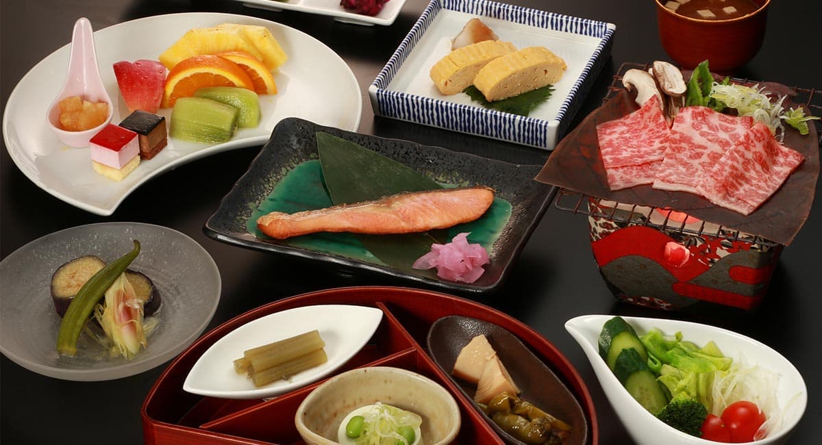 Hida beef and kaiseki-style dinner spread with grilled fish, fruit and assorted small dishes at Oyado Koto no Yume, Takayama
