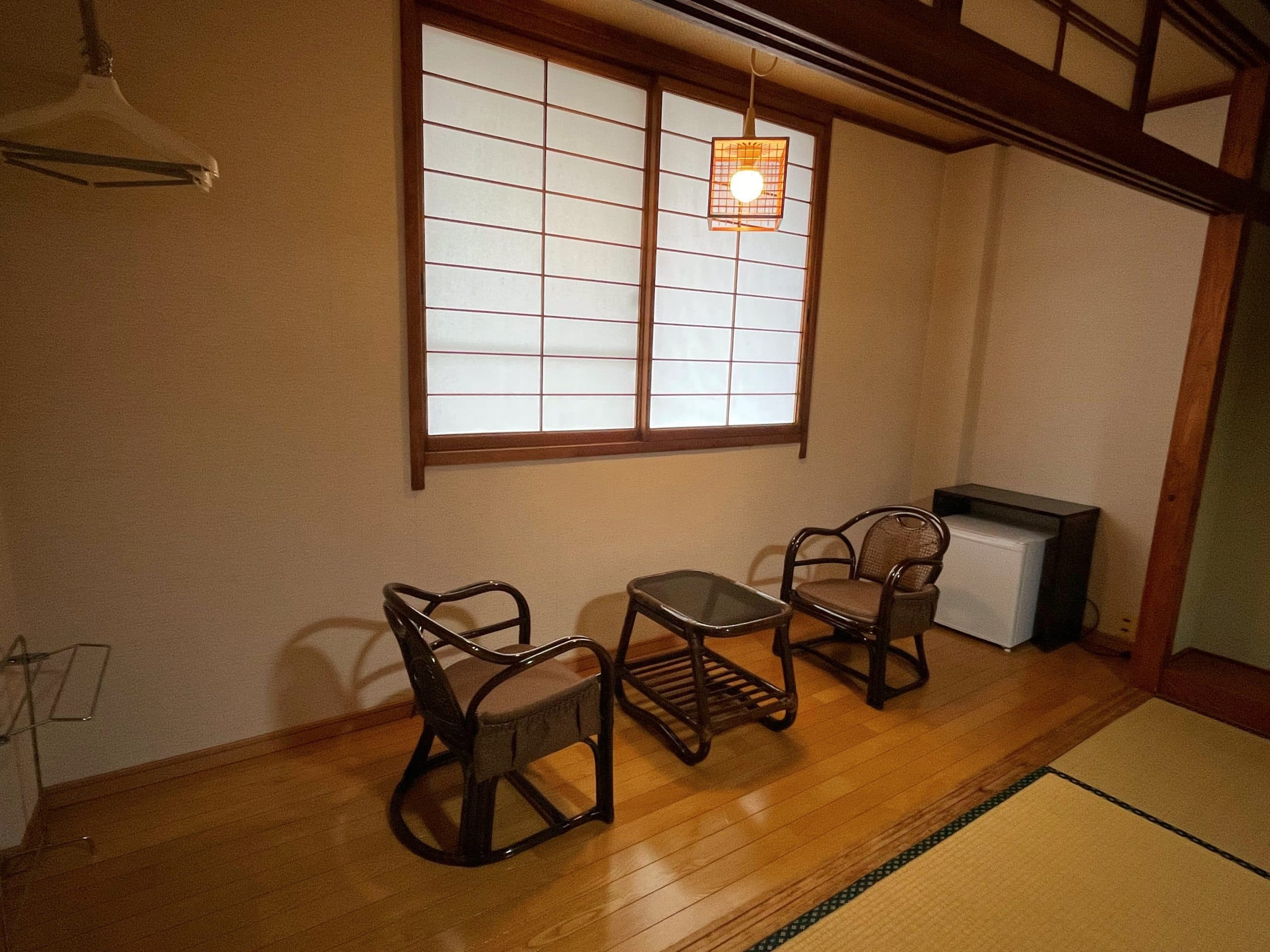 Bright Japanese-style tatami room with floor cushions and wood ceiling at Matsunoki-tei