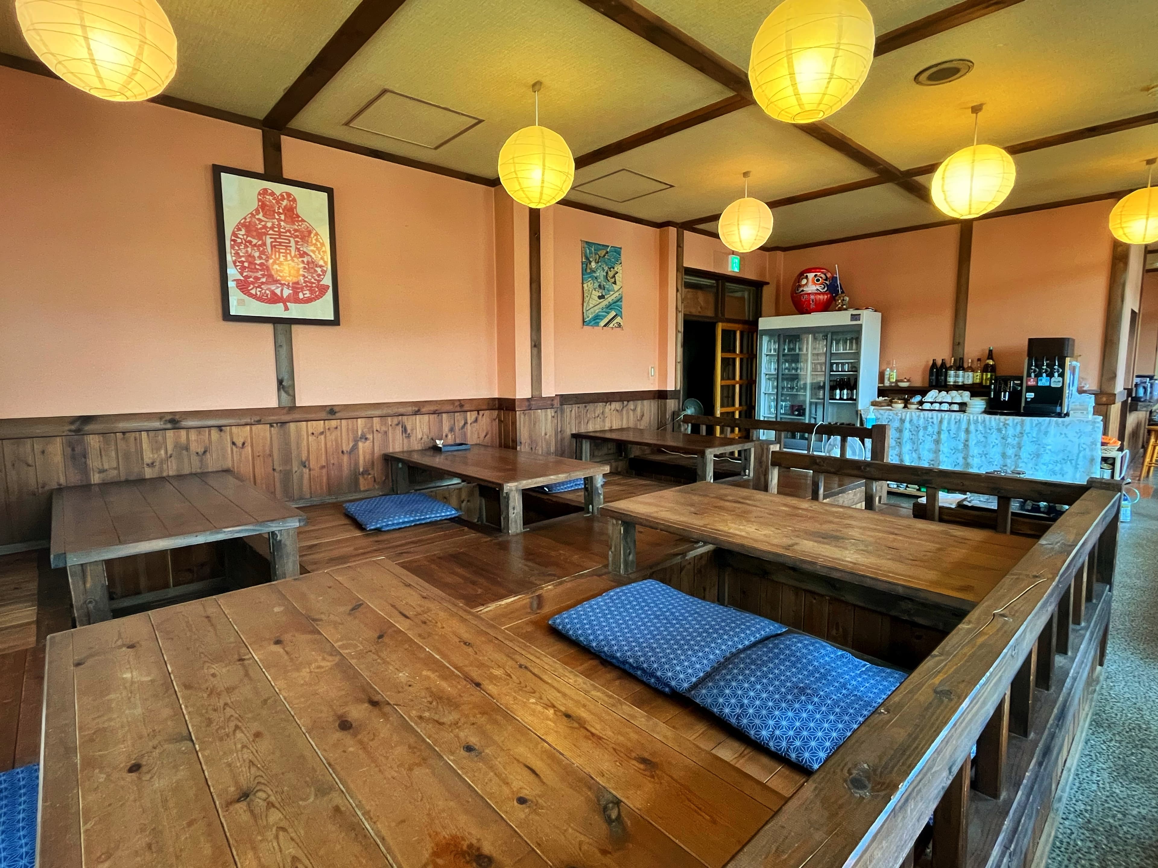 Wooden dining lounge with sunken kotatsu tables and paper lanterns at Matsunoki-tei in Hakuba