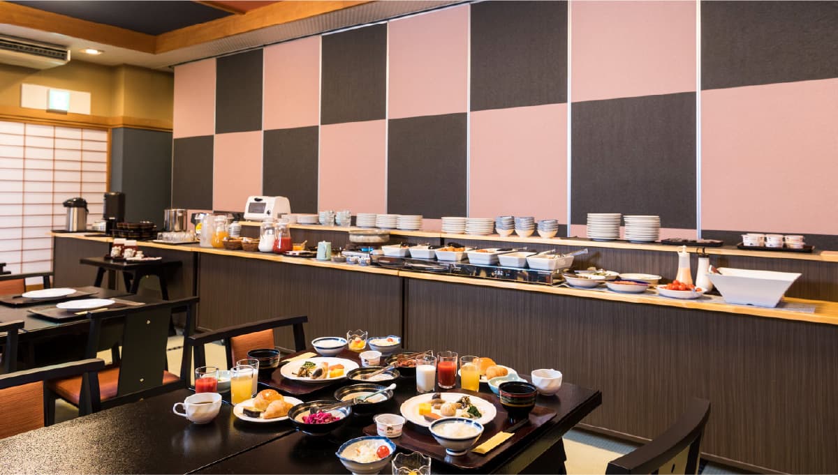 Japanese breakfast buffet laid out along a counter in the dining room at Meitoya So in Zao Onsen