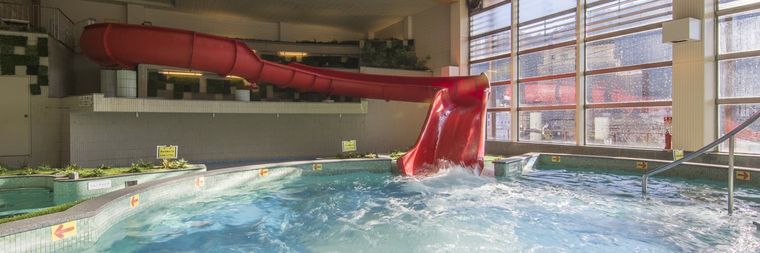 Indoor swimwear spa pool with a red waterslide