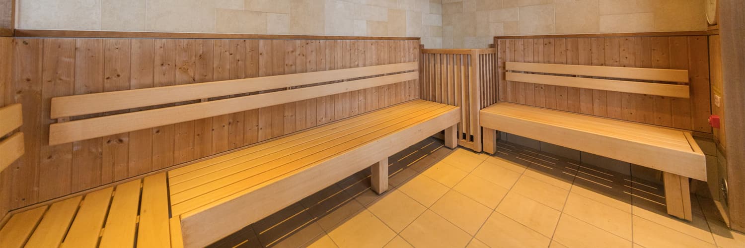 Wooden sauna room with tiered benches