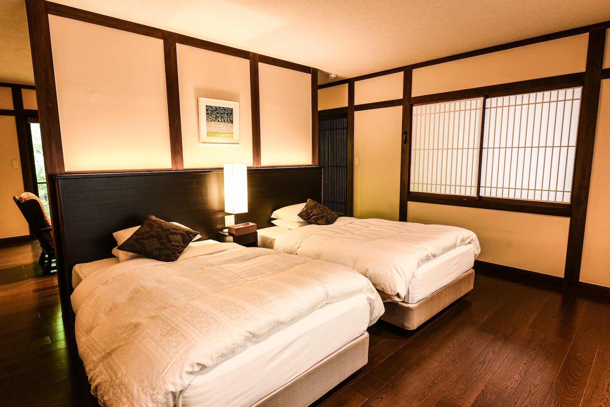Premium twin guest room with paper-screen walls, hardwood floor and traditional timber detailing
