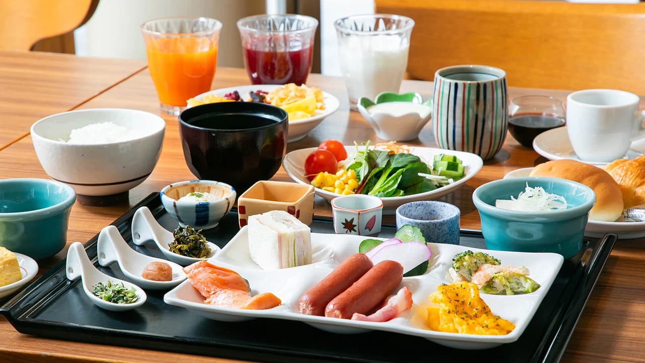Japanese breakfast tray with grilled fish, side dishes, salad and fresh juices at Oku Nikko Mori no Hotel