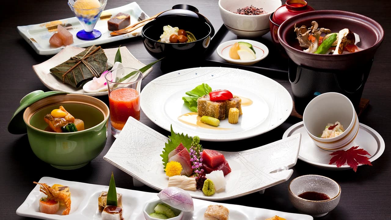 Multi-course kaiseki dinner spread of seasonal Japanese dishes plated on the table at Oku Nikko Mori no Hotel