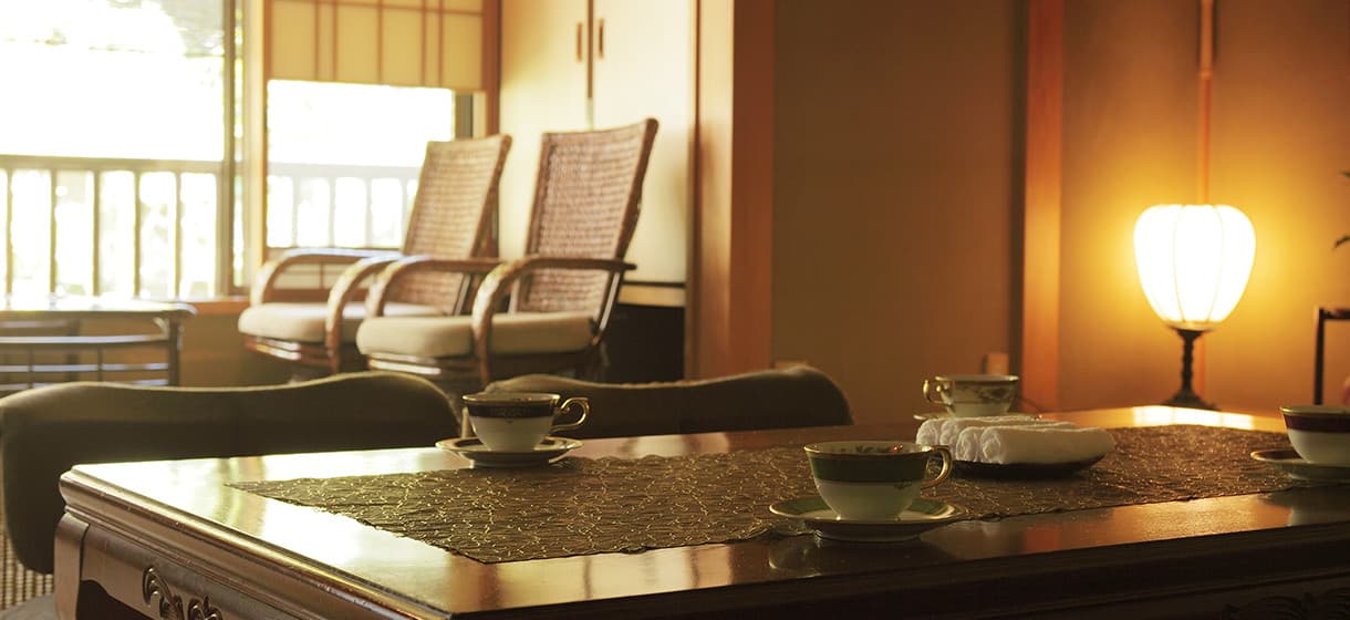 Relaxation lounge corner at Morizuya with rattan reclining chairs, tea service and a paper lantern