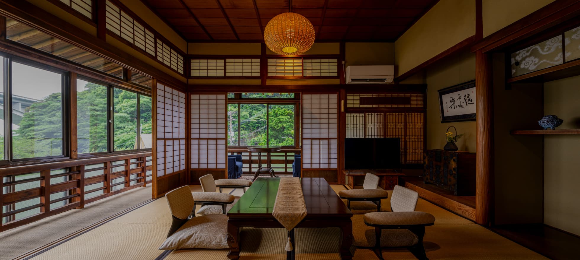 Traditional tatami guest room with shoji screens, paper lantern and low table facing a green garden view, Okamotoya Ryokan, Myoban Onsen, Beppu
