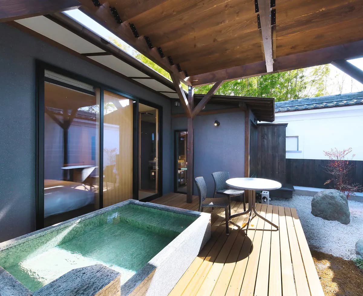 Private open-air rotenburo bath on a wooden deck at Fuji Onsenji Yumedono guest room