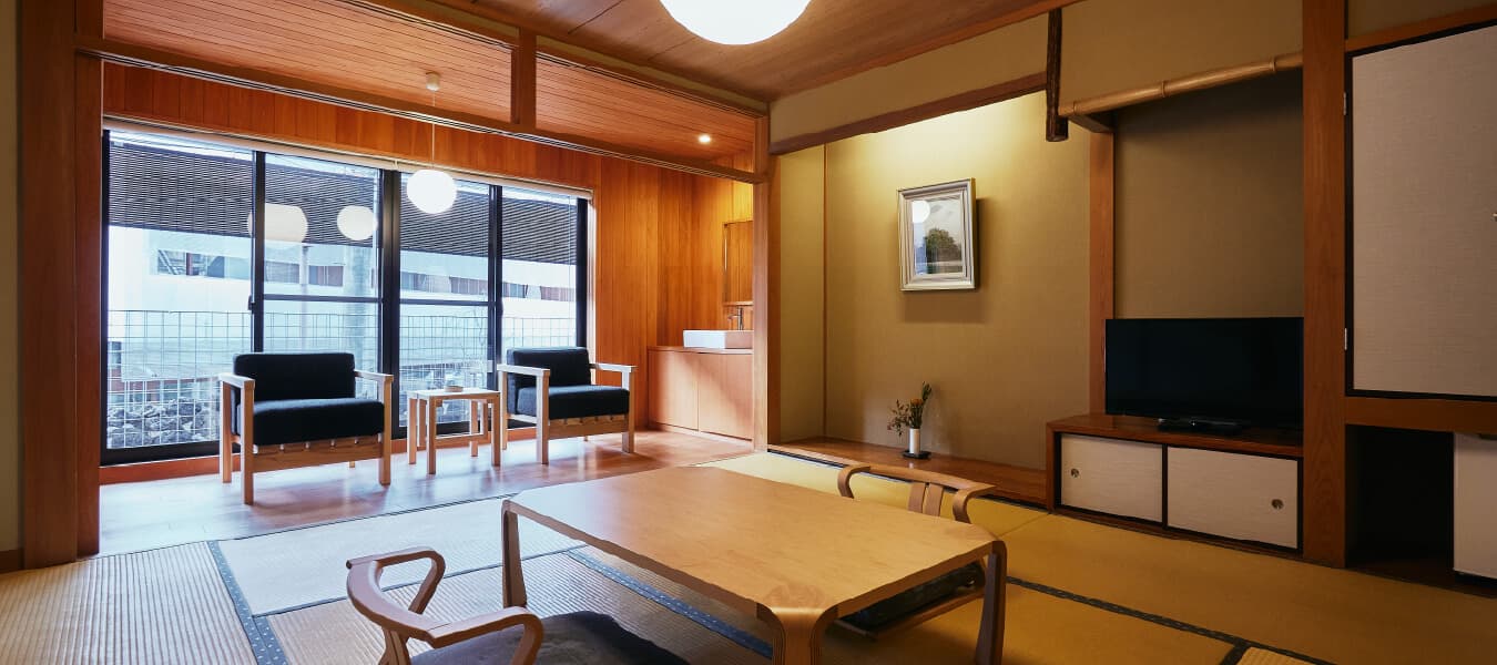 Traditional tatami guest room at Tsuchiya with low table, floor chairs and a tokonoma alcove