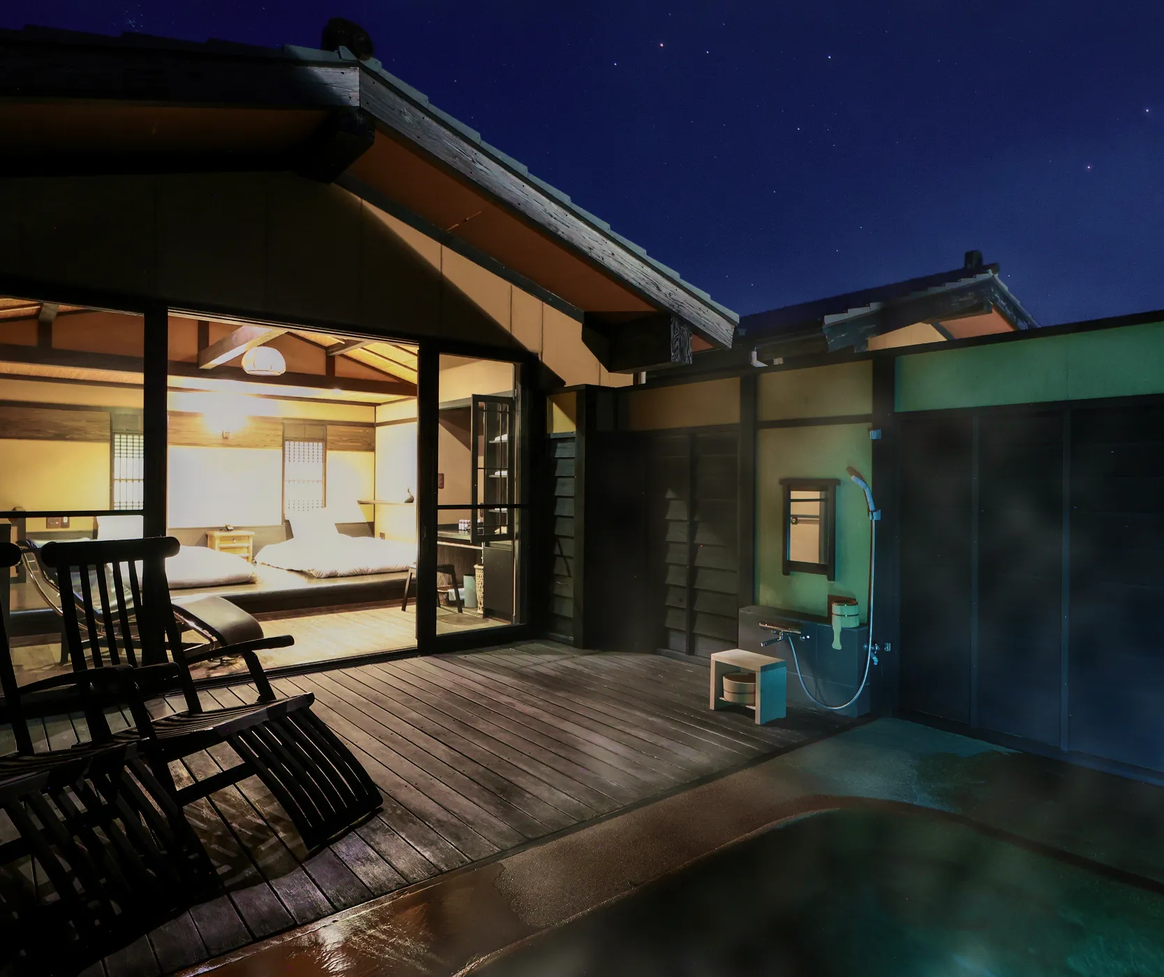 Hana guest room at Oyado Uchiyama with private open-air bath on a wooden terrace under a starry night sky