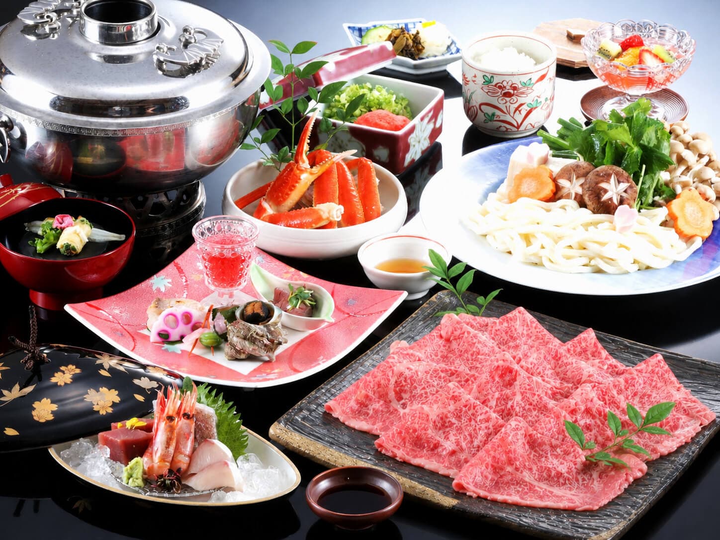 Tajima beef shabu-shabu set with marbled sliced beef, crab and vegetables beside a silver hotpot, Onishiya Suishoen, Kinosaki Onsen