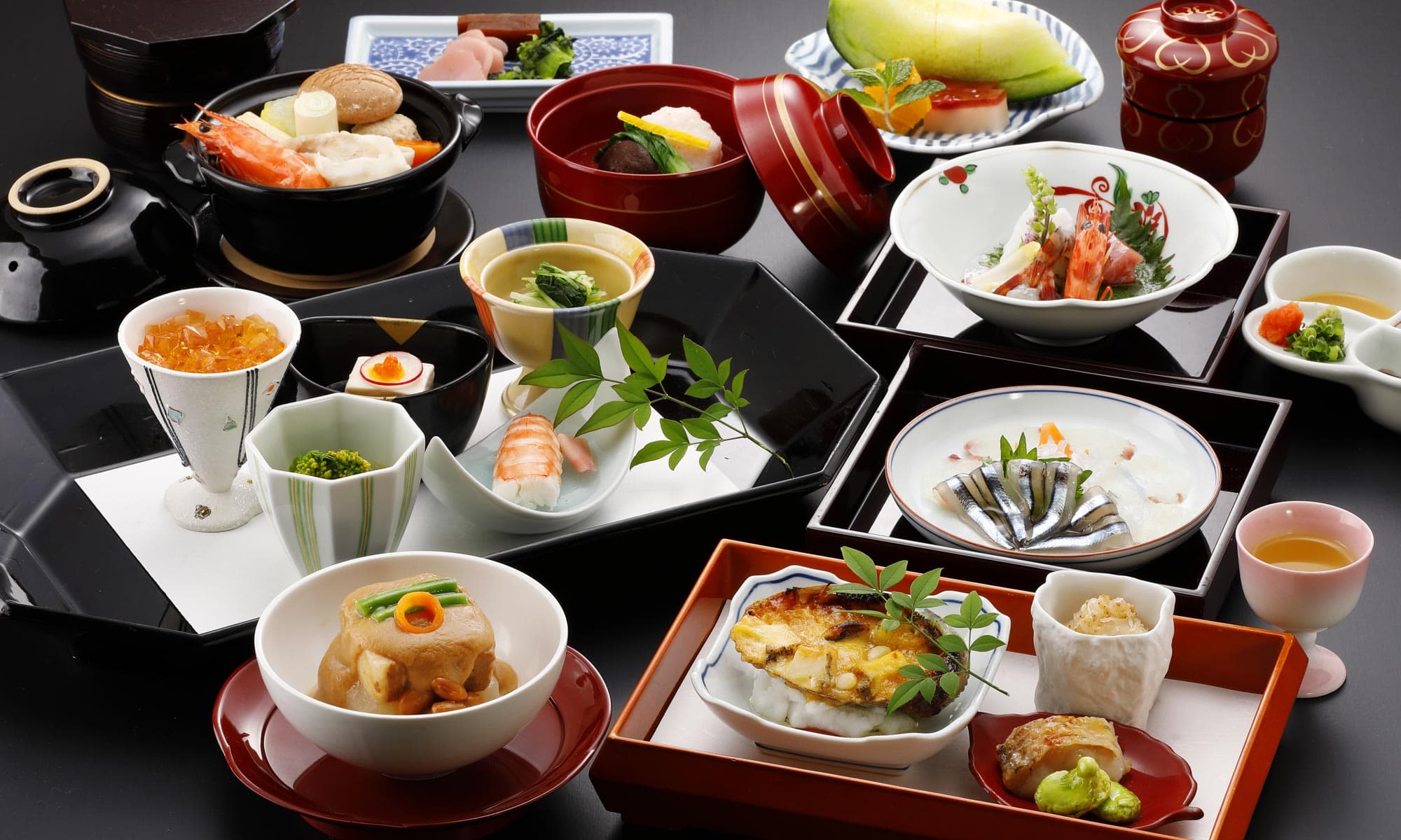 Award-winning multi-course kaiseki dinner spread at Ibusuki Shusuien with sashimi, hot pot and lacquerware