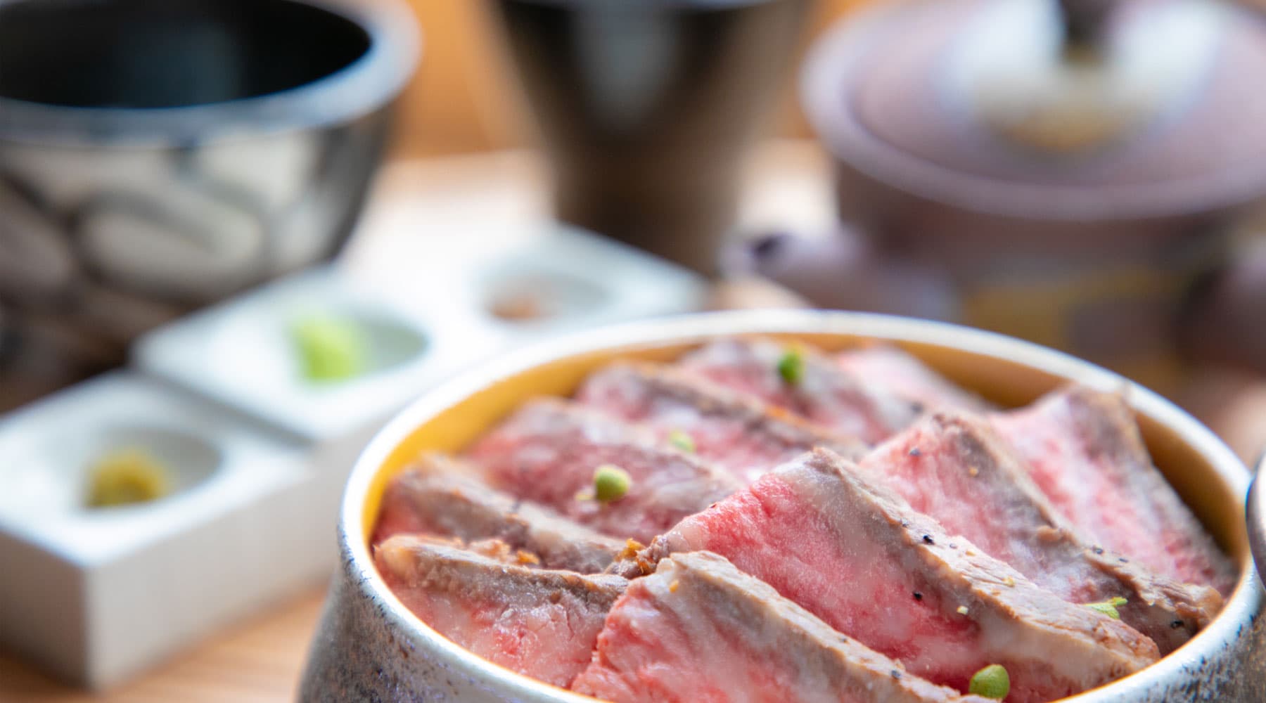 Sliced Tajima beef rice pot with wasabi and condiments served at Tokitotoki