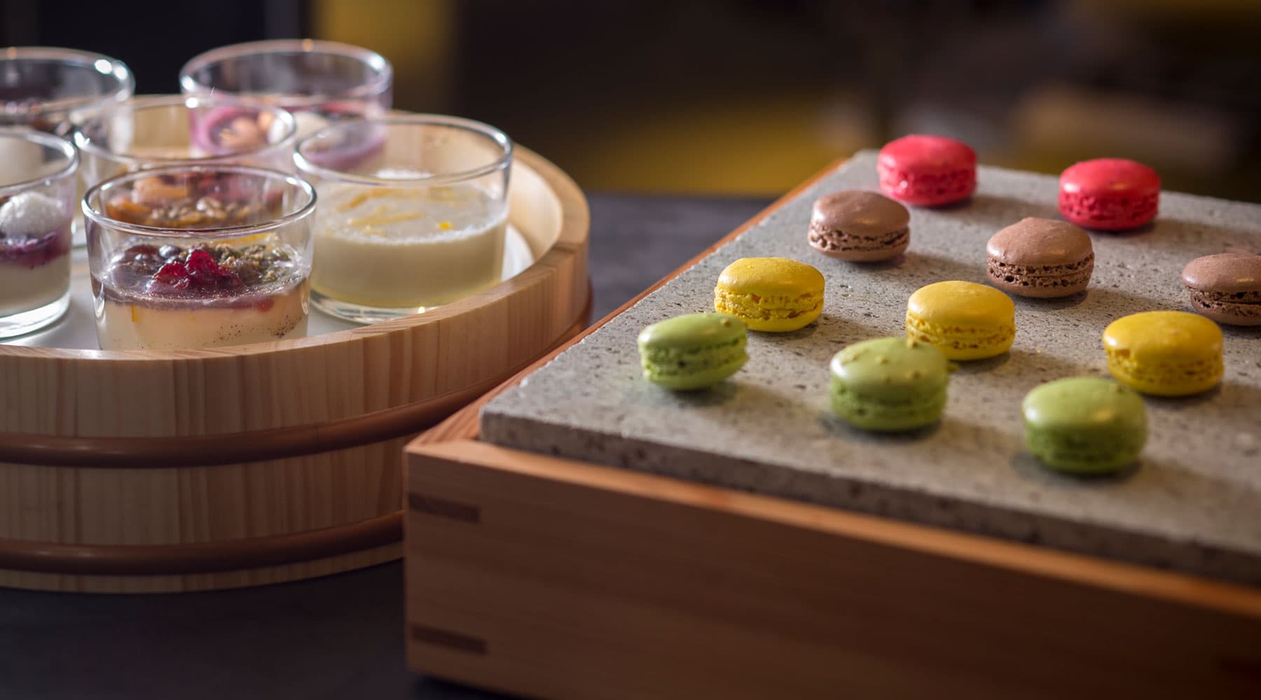 Colorful macarons and chilled dessert cups presented on cedar trays at Tokitotoki