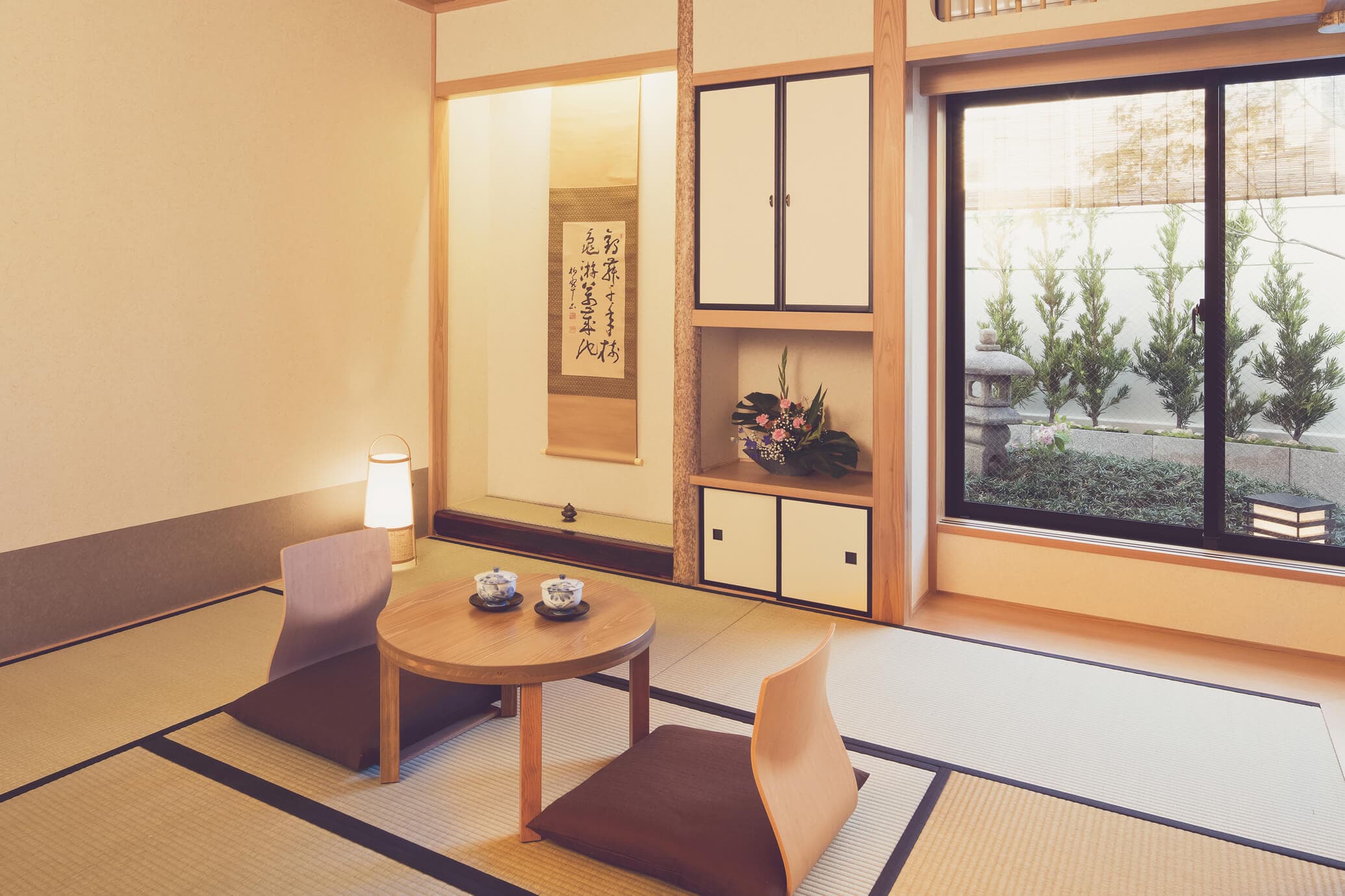 Bright tatami guest room with picture window onto a small Japanese garden at The Edo Sakura, Tokyo