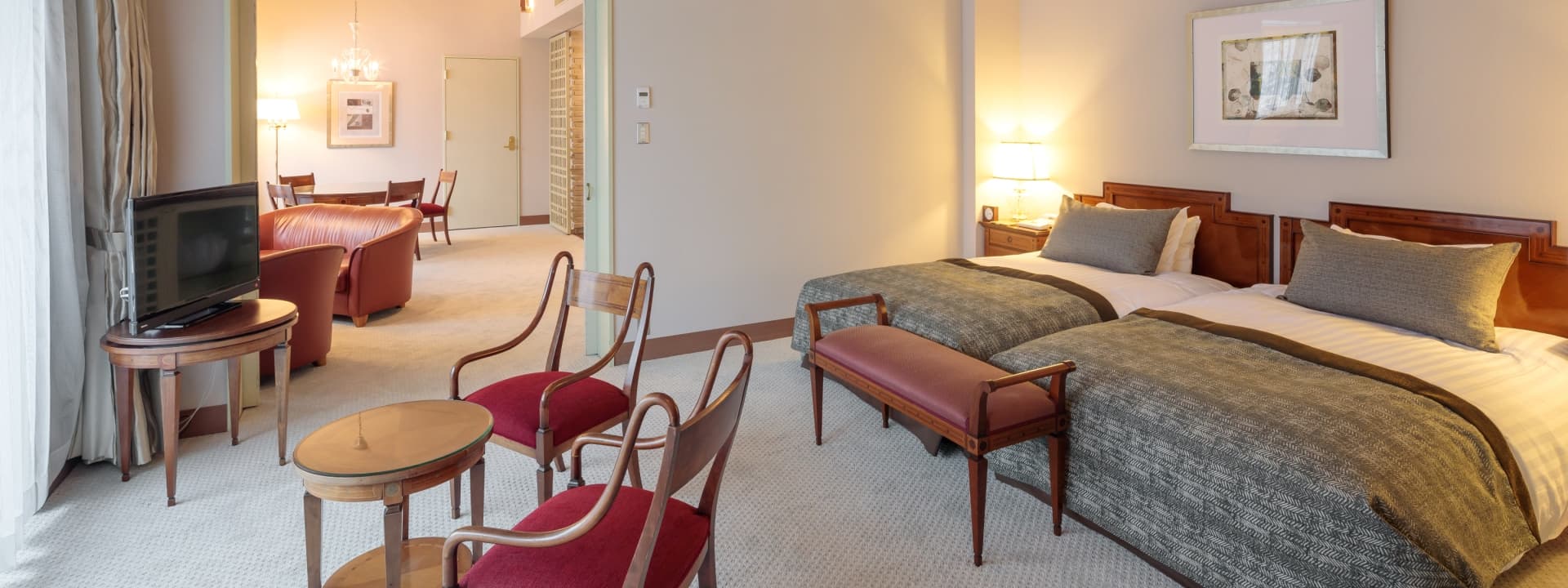 Spacious suite at Hakuba Tokyu Hotel with twin beds, a sitting lounge and classic wood furnishings