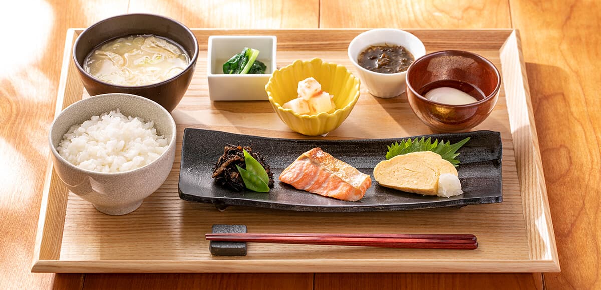 Japanese breakfast set tray with rice, miso soup, grilled salmon and tamagoyaki at Tokyu Stay Hida Takayama
