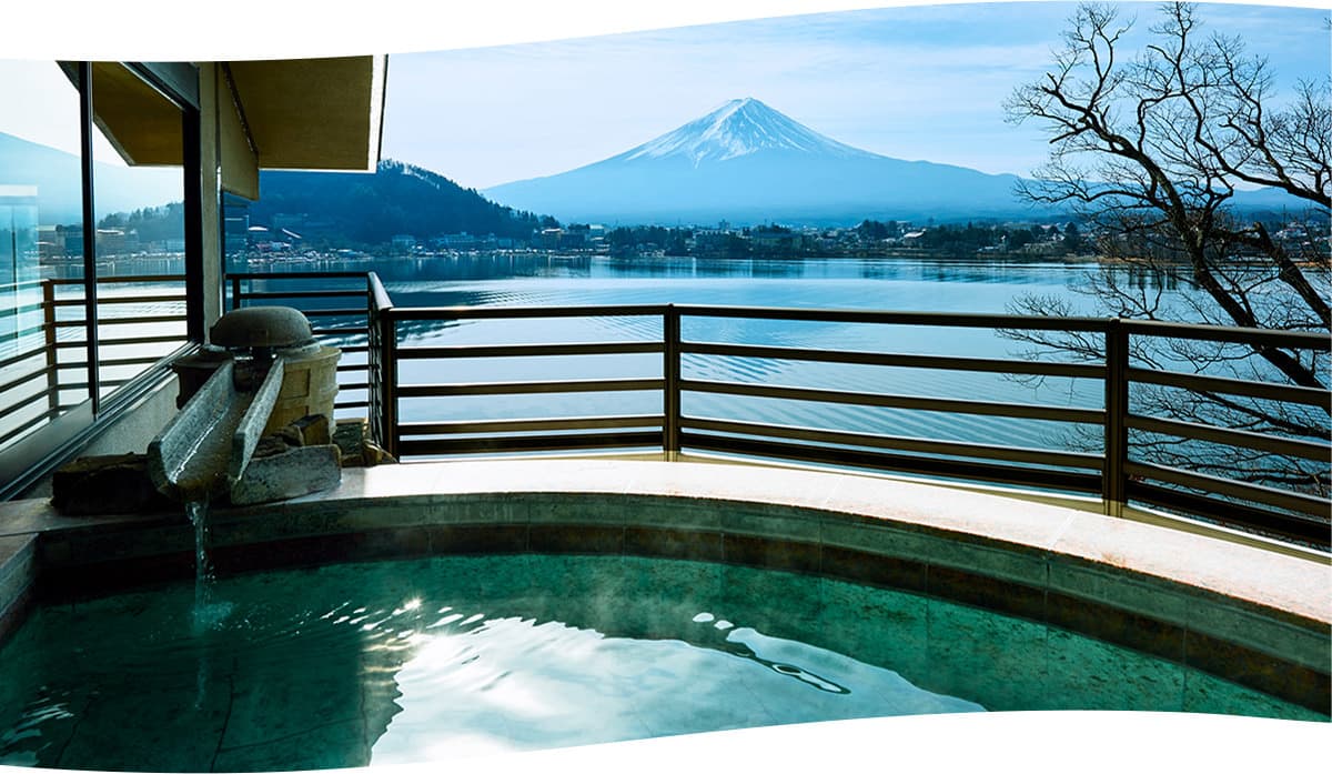 Lakeside outdoor hot spring at Kozantei Ubuya overlooking Mt. Fuji and the town along Lake Kawaguchiko
