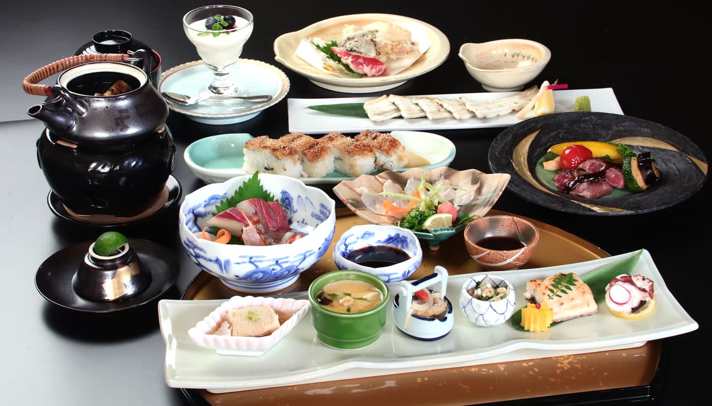 Multi-course kaiseki dinner spread with sashimi, grilled fish and seasonal small dishes at Yamaichi Bekkan, Miyajima