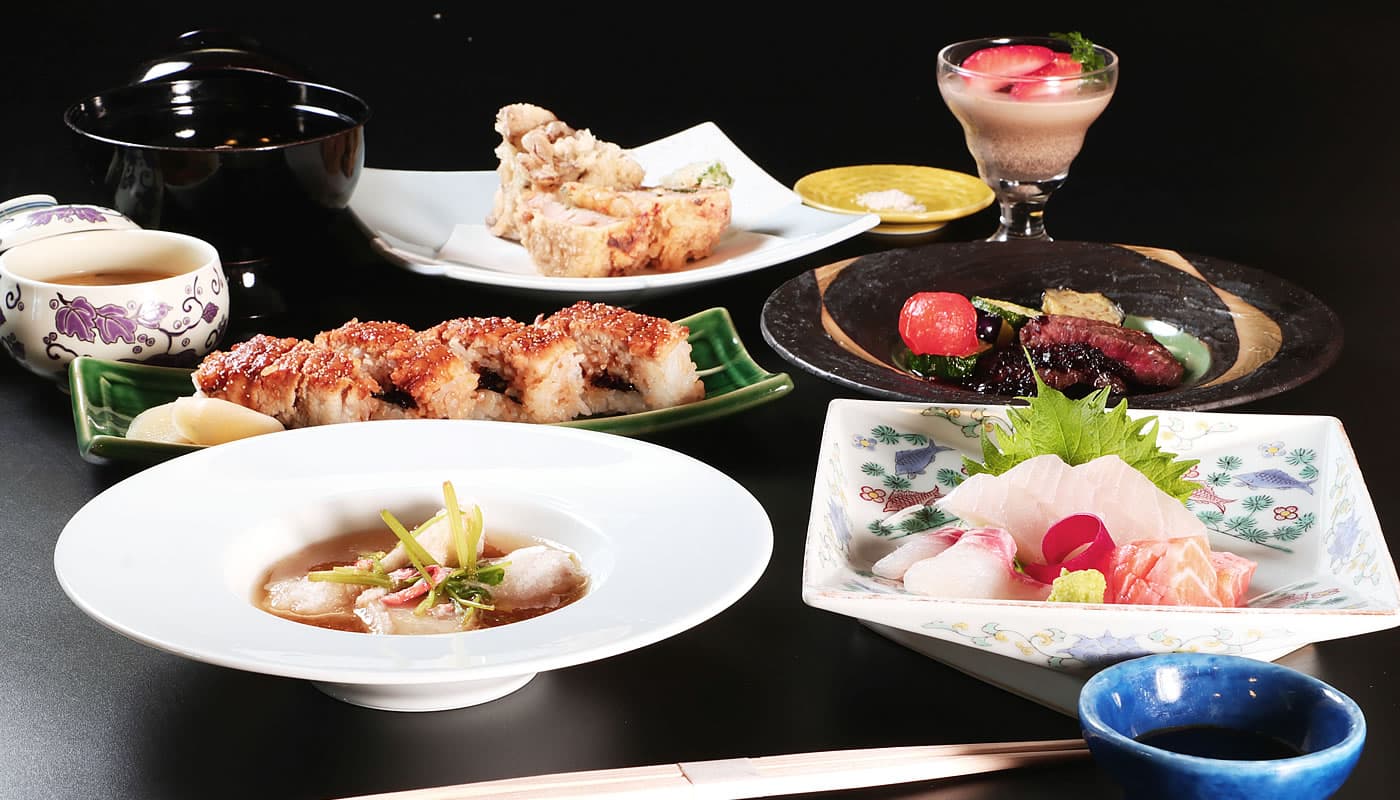 Kaiseki dinner course featuring sashimi, anago sushi and assorted dishes at Yamaichi Bekkan on Miyajima island