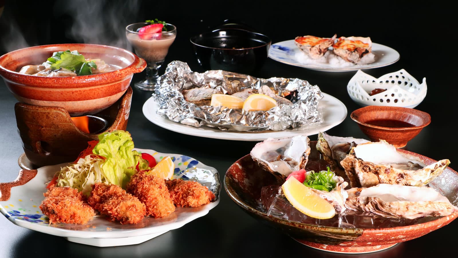 Seafood kaiseki spread with grilled oysters and hot pot, Miyajima specialties, at Yamaichi Bekkan