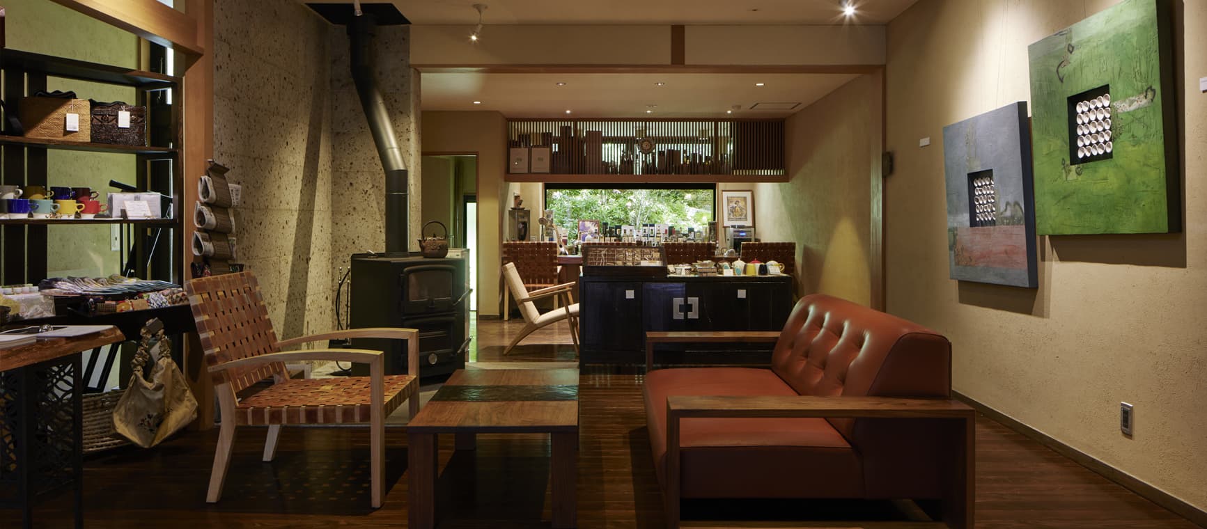 Lounge and cafe with a wood-burning stove, leather sofa and contemporary art