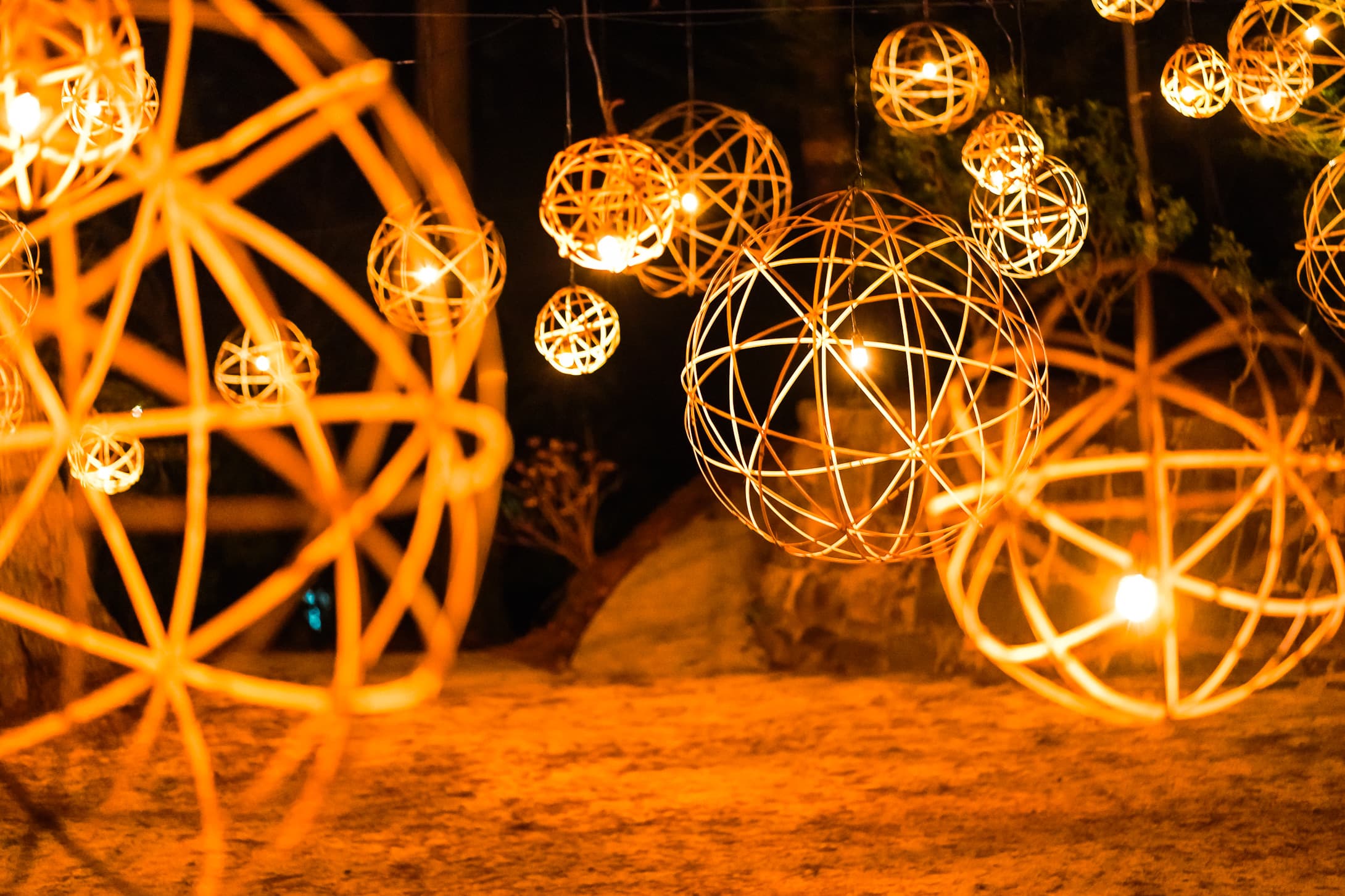 Ryokan Yamanoyu illuminated woven bamboo sphere lanterns glowing in the night garden
