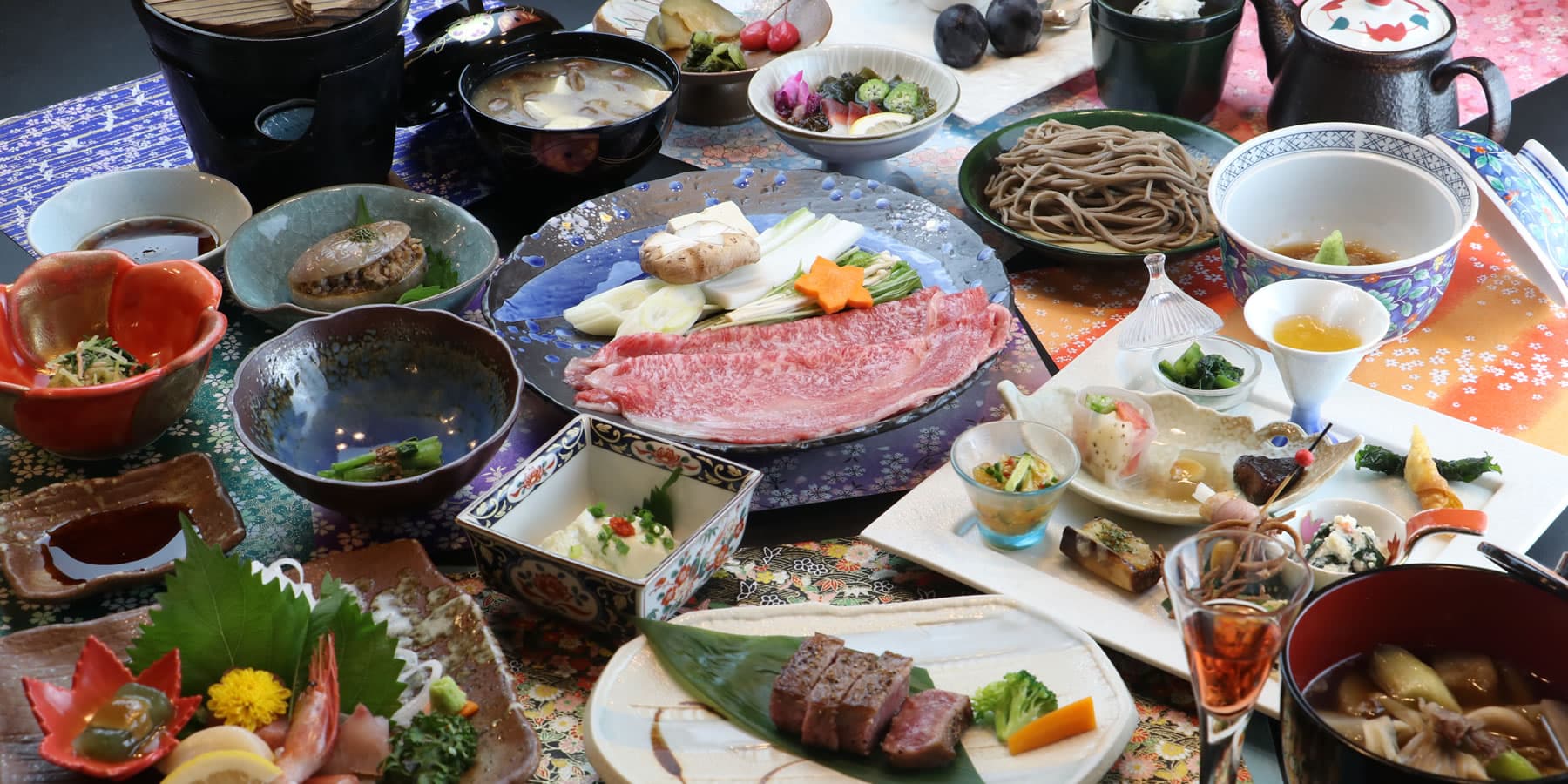 Multi-course kaiseki dinner with Yamagata wagyu sukiyaki, sashimi and soba laid out at Oyado Yanadaya