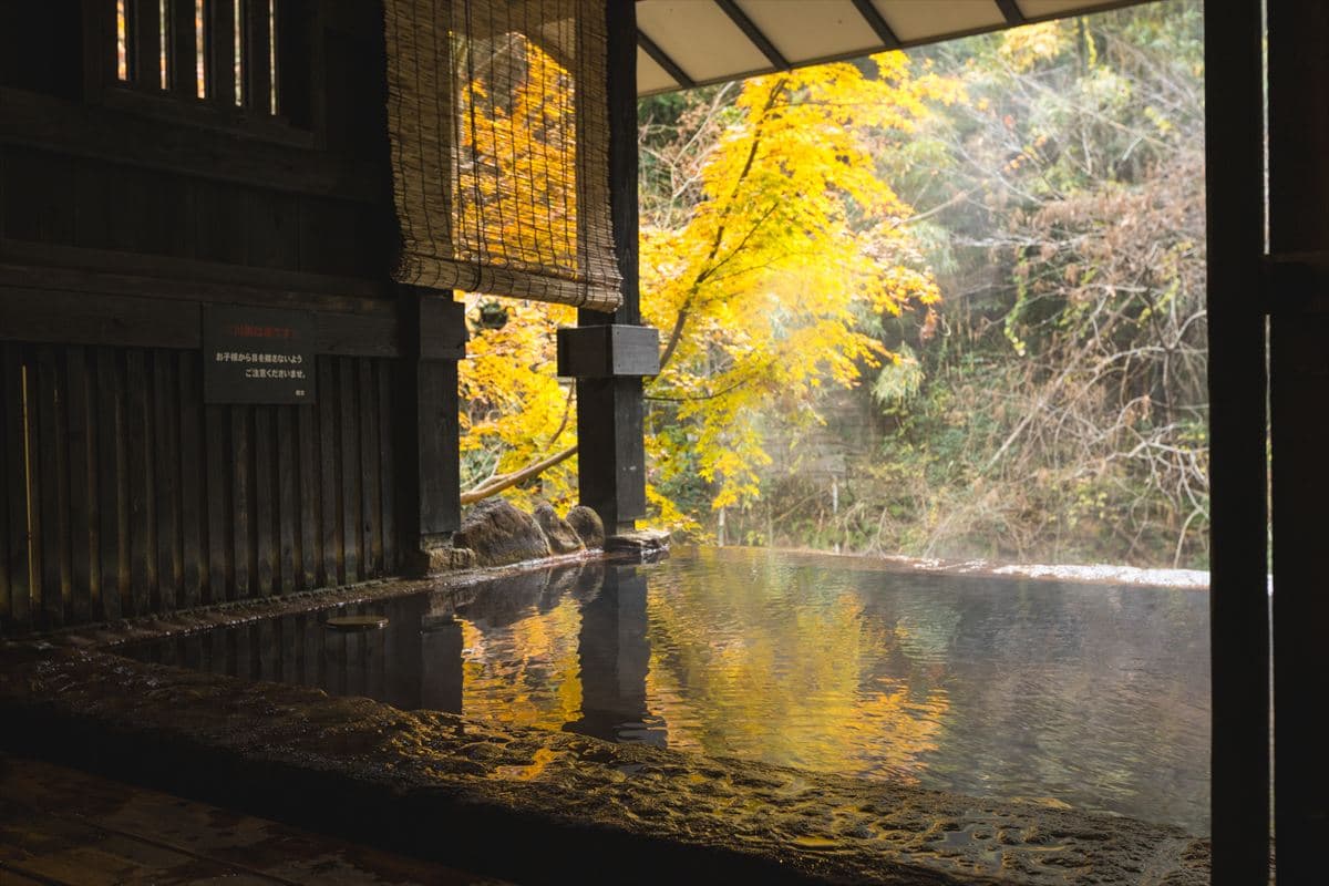 Ryokan Yumotoso Kajika outdoor rotenburo hot spring bath lit in the evening