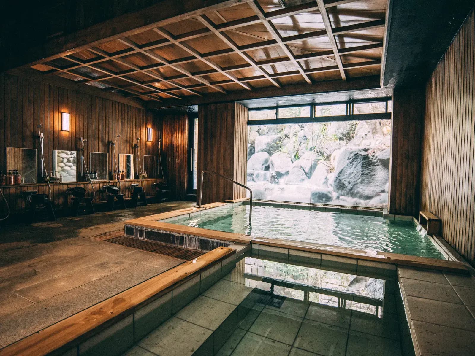 Indoor bath with a rock and gorge view