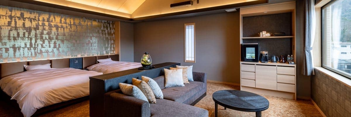 Hatago Room 201 premium suite with twin beds, gold-leaf wall art, lounge sofa and modern minibar nook