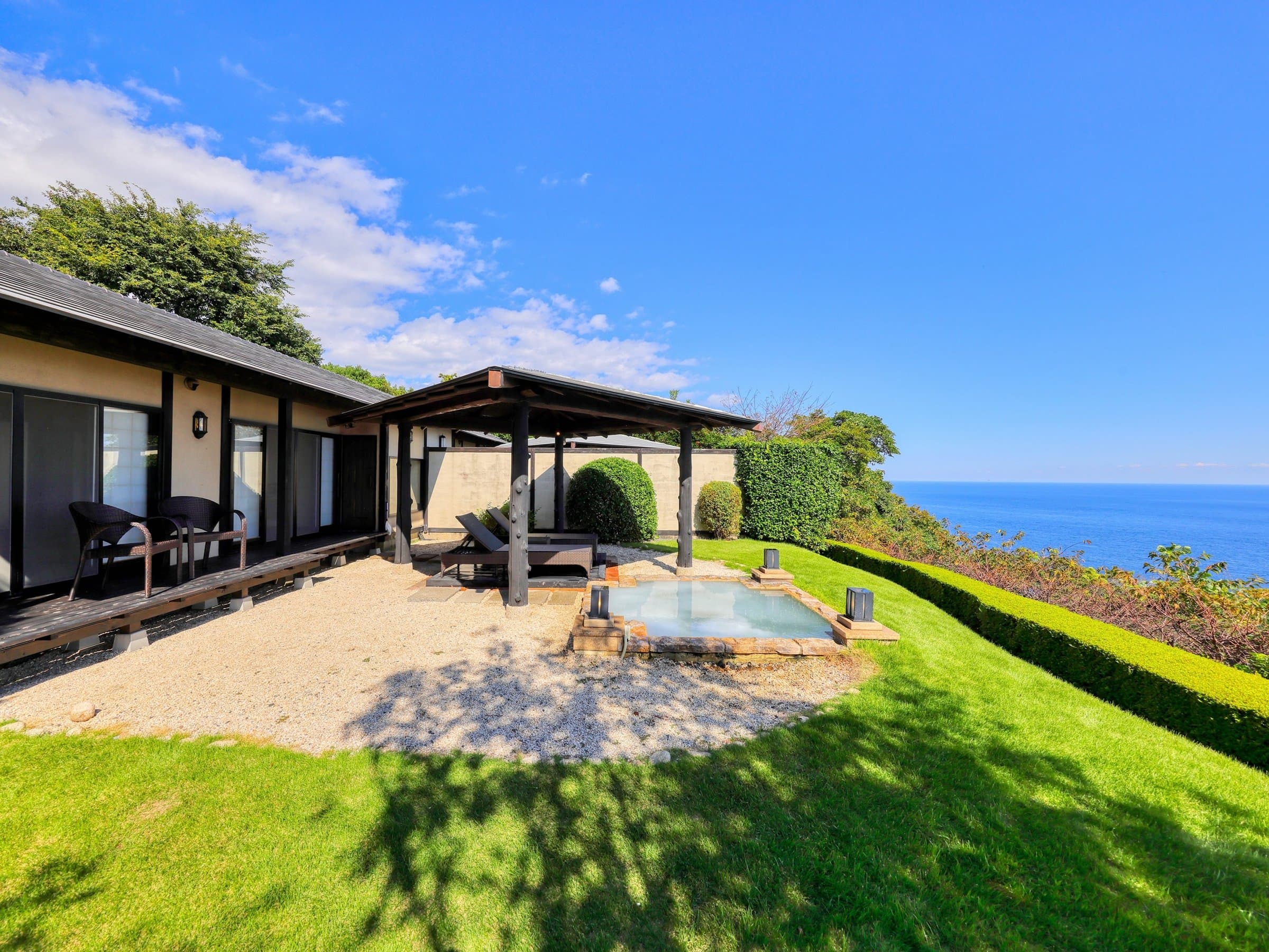 Detached villa exterior at Tsuki no Usagi in Izu-Kogen with a private open-air bath, sun deck and clifftop ocean view