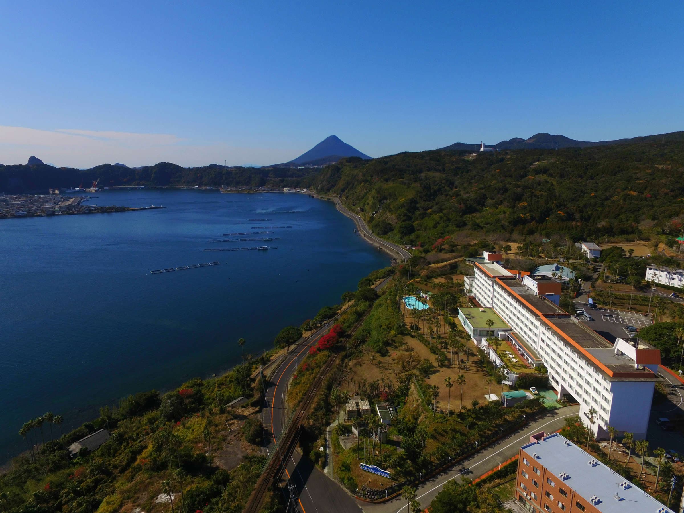 Aerial view of Ibusuki Phoenix Hotel resort above Kinko Bay with Mt. Kaimon on the horizon in Ibusuki, Kagoshima
