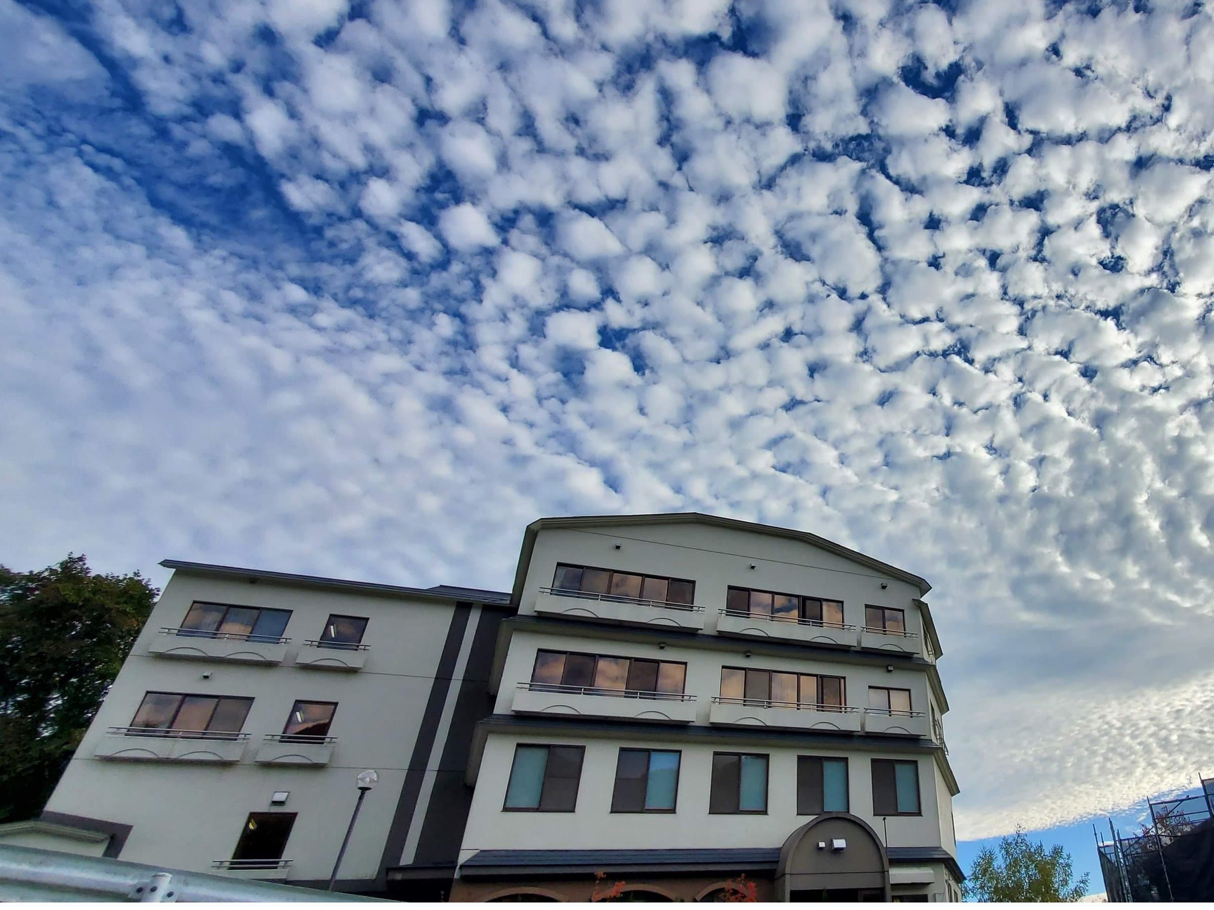 Full daytime exterior of Zao Plaza Hotel under an autumn mackerel sky in Zao Onsen