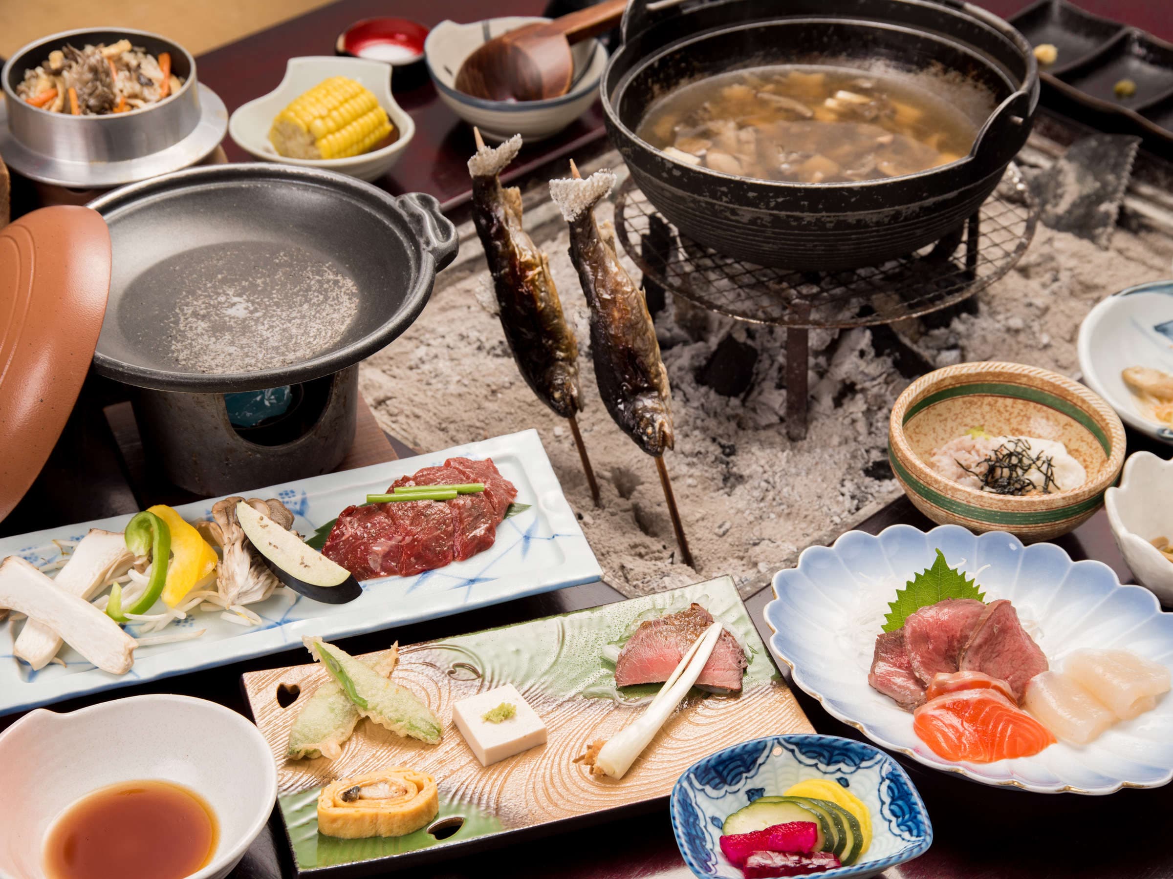 Multi-course kaiseki dinner with charcoal-grilled river fish, sashimi, simmering hot pot and seasonal side dishes
