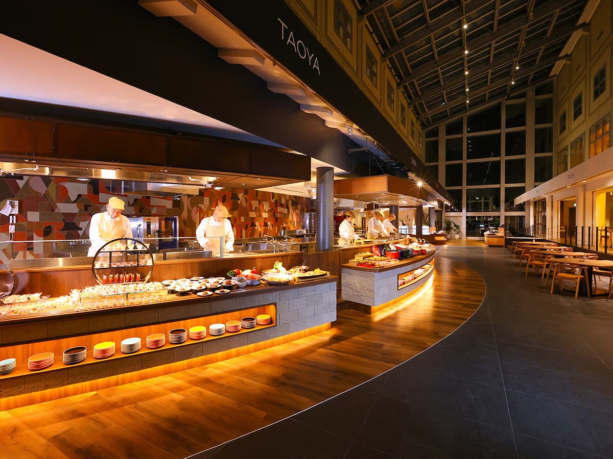Warmly lit open-kitchen buffet hall with live cooking stations at TAOYA Nikko Kirifuri