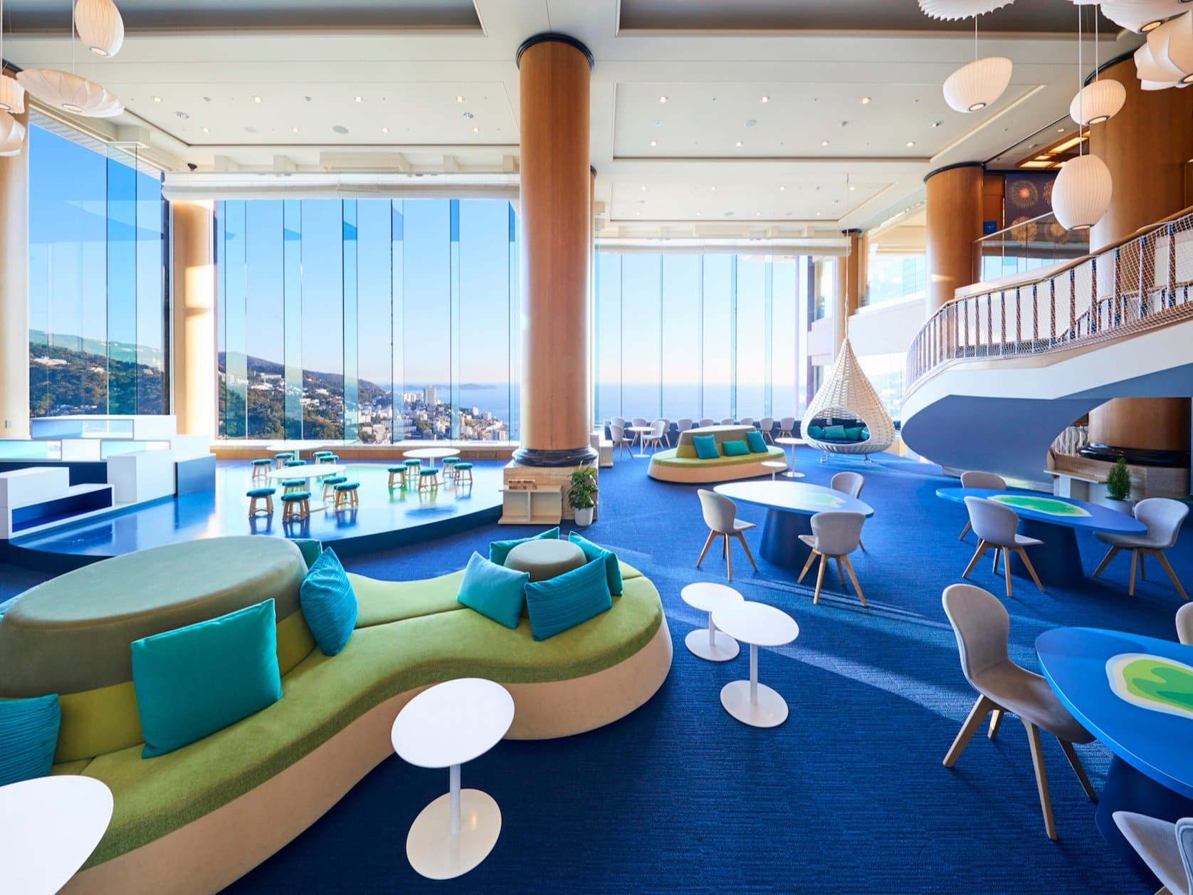 Risonare Atami Sola no Books library lounge with floor-to-ceiling windows over Atami Bay