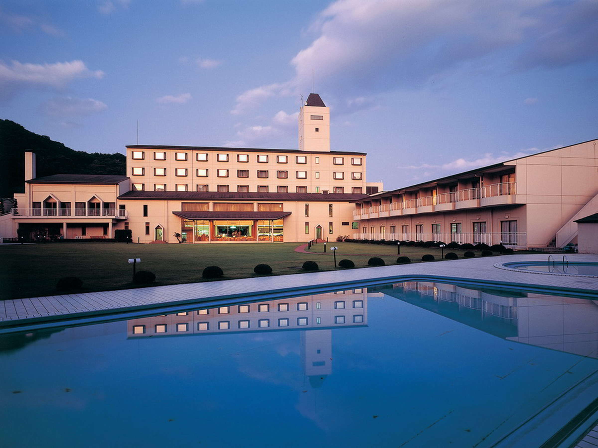 Akiu Resort Hotel Crescent exterior at dusk with reflecting pool and tower in Akiu Onsen, Sendai