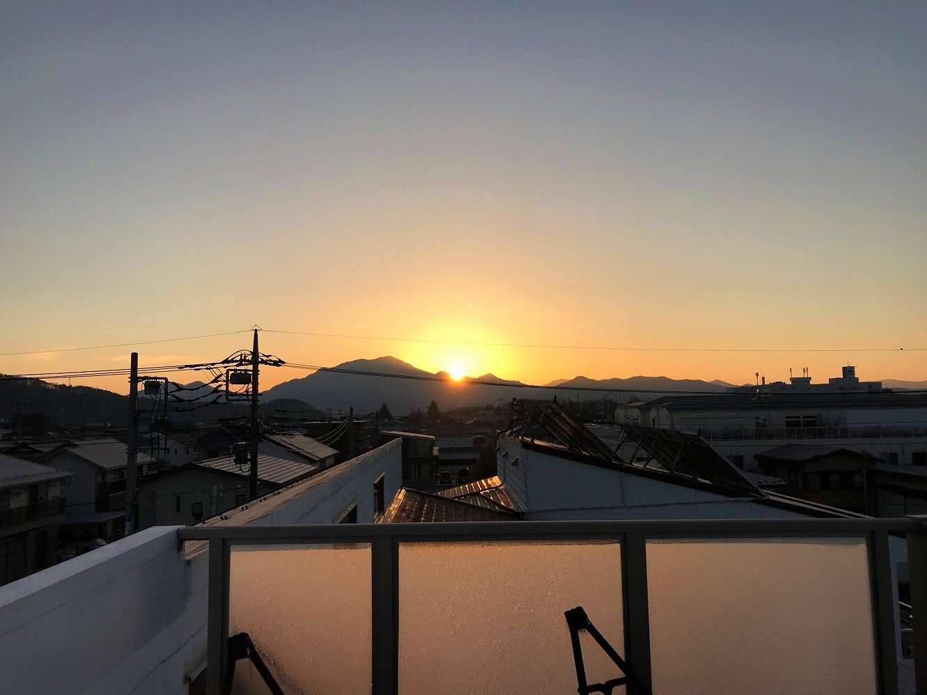 Sunset over the mountains seen from the rooftop terrace of K's House Fuji View