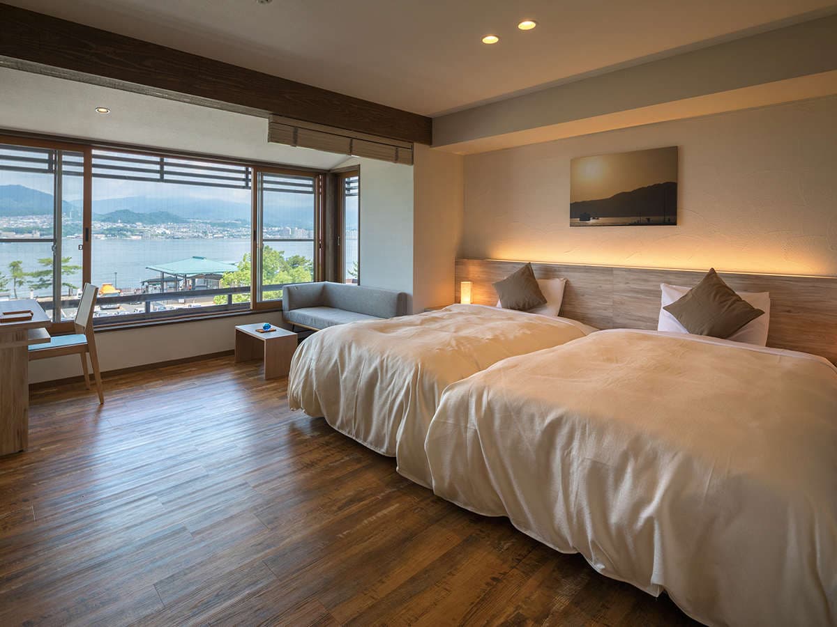 Twin guest room at Hotel Miyajima Villa with corner window overlooking the Seto Inland Sea